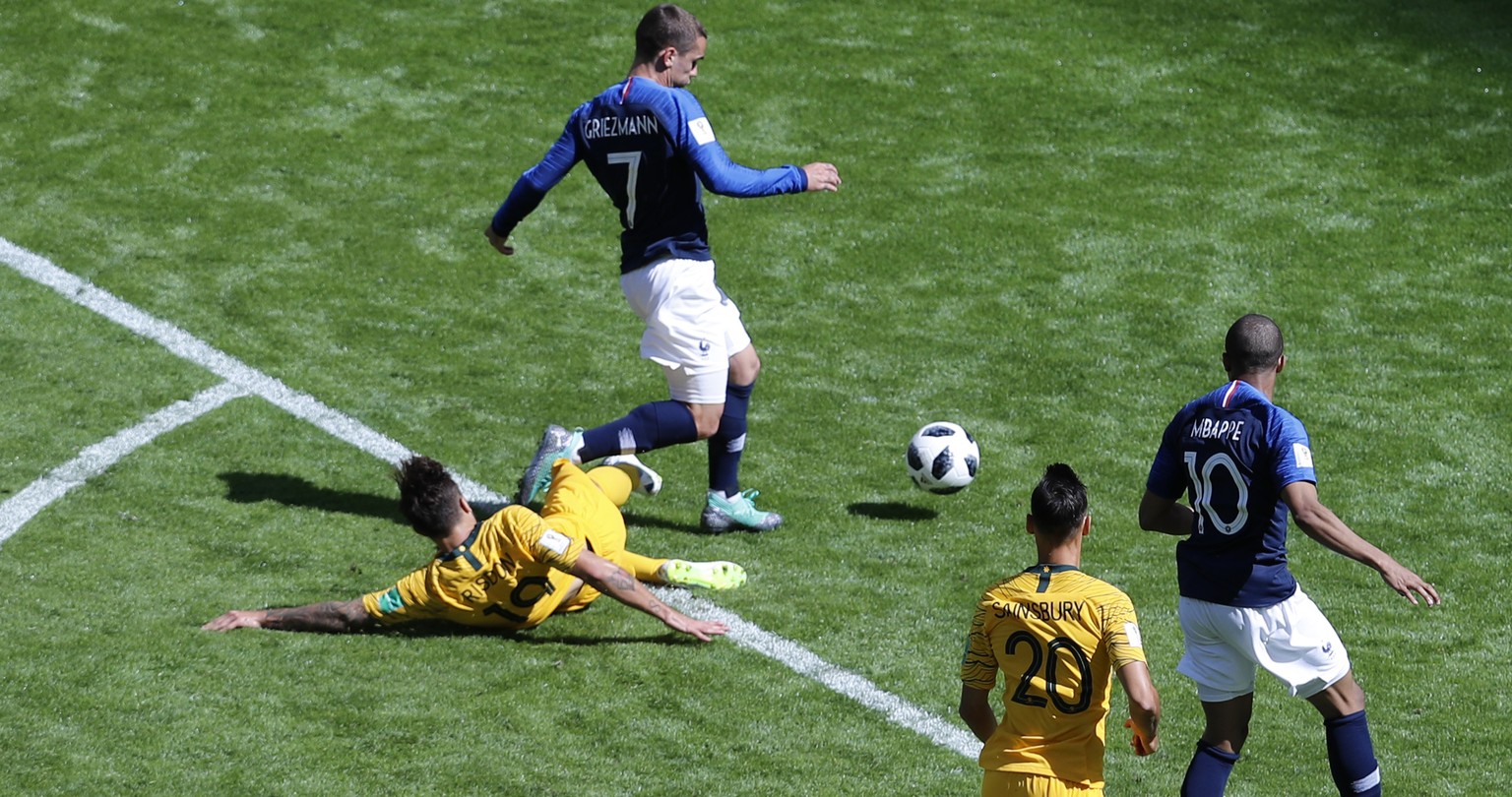 Australia&#039;s Joshua Risdon, left, tackles France&#039;s Antoine Griezmann, second left conceding a penalty kick for France during the group C match between France and Australia at the 2018 soccer  ...