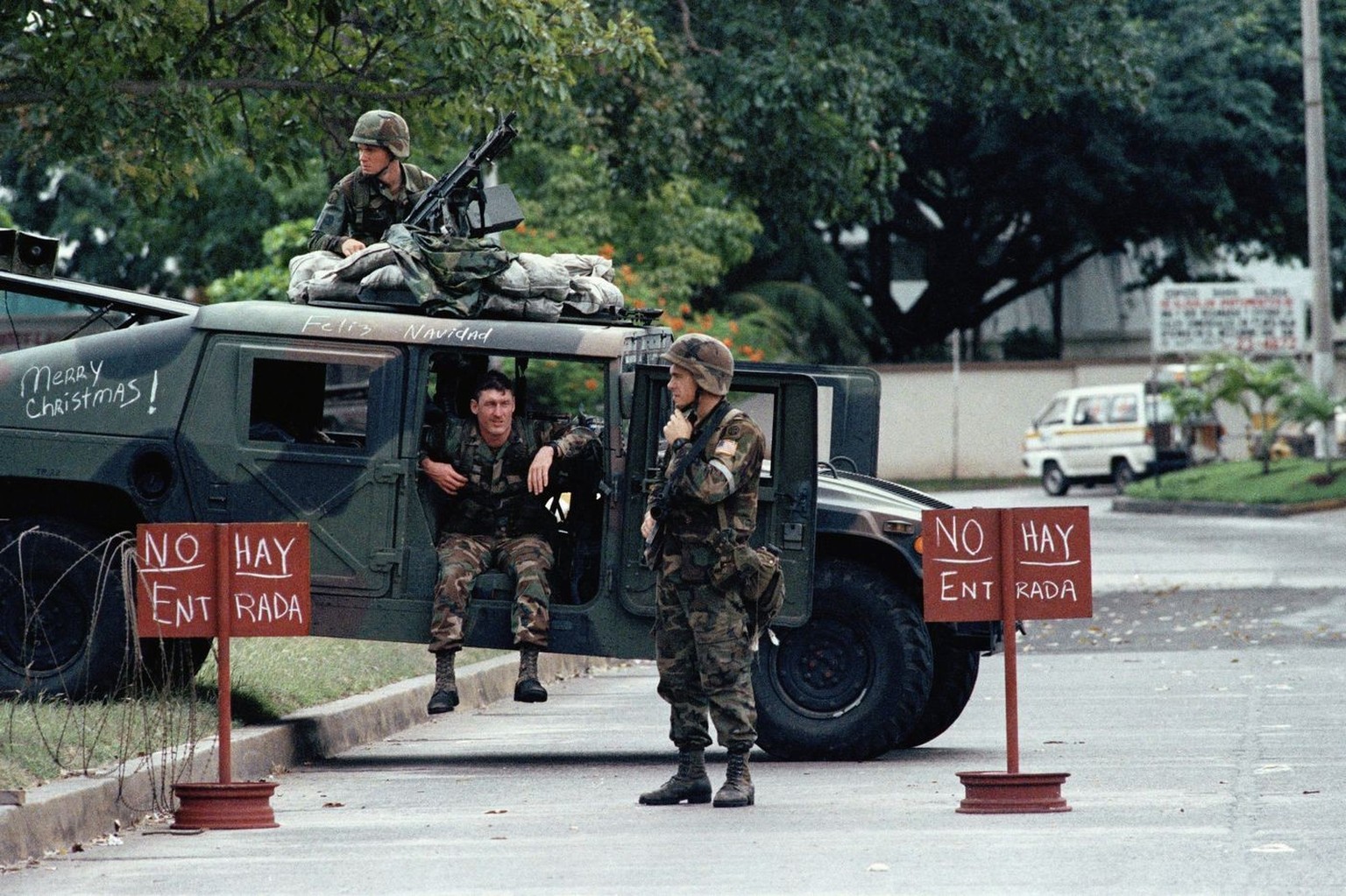 American soldiers man a roadblock Dec. 26, 1989 in Panama City, preventing access to the Vatican Embassy where Manuel Noriega has sought refuge. The sign in spanish says "No Entrance." (AP P ...