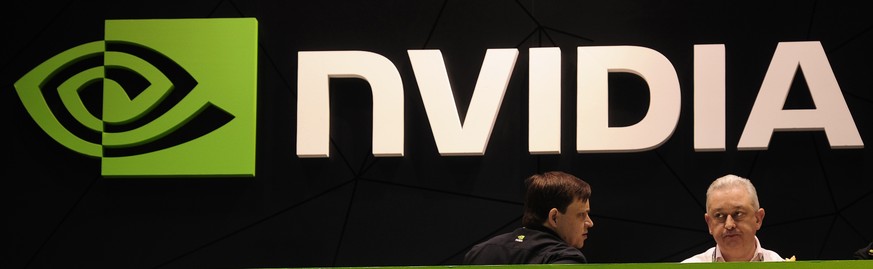 FILE - In this Thursday, Feb. 27, 2014 file photo, people gather in the Nvidia booth at the Mobile World Congress mobile phone trade show in Barcelona, Spain. European Union regulators opened an in-de ...