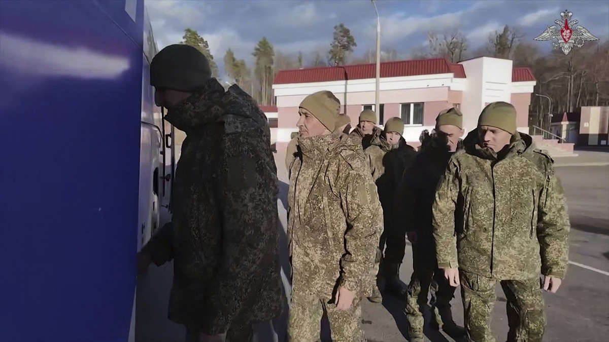 In this photo taken from video distributed by Russian Defense Ministry Press Service on Wednesday, March 19, 2025, a group of Russian soldiers lineup to board a bus after being released in a prisoners ...