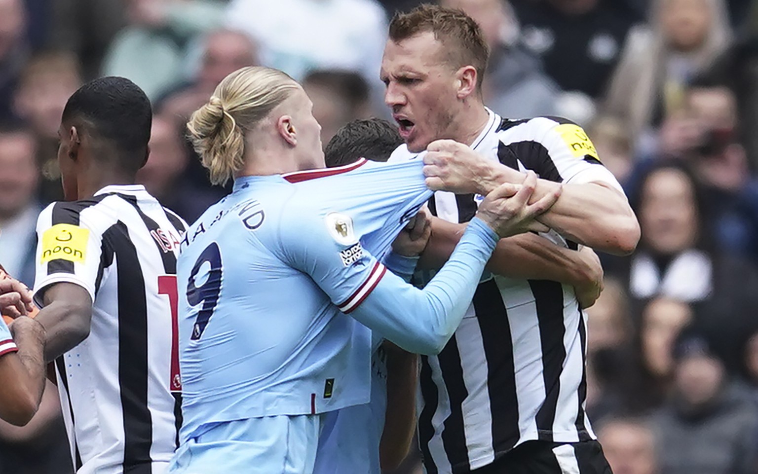 Manchester City&#039;s Erling Haaland, left, argues with Newcastle&#039;s Dan Burn during the English Premier League soccer match between Manchester City and and Newcastle, at the Etihad stadium in Ma ...