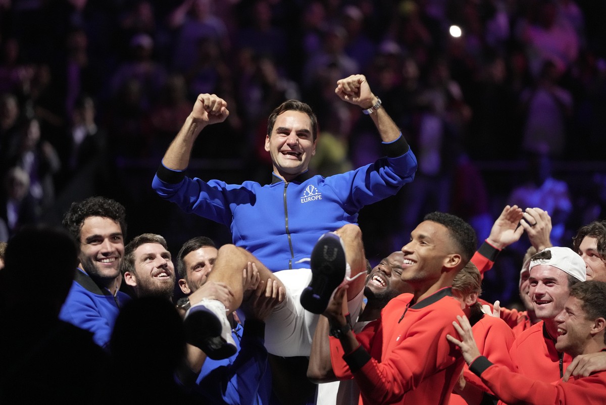 Team Europe's Roger Federer is lifted by fellow players after playing with Rafael Nadal in a Laver Cup doubles match against Team World's Jack Sock and Frances Tiafoe at the O2 arena in Lond ...