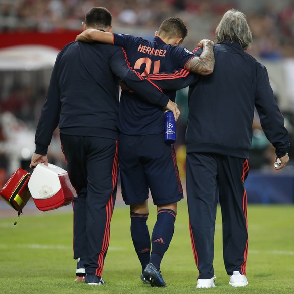 Bayern&#039;s injured Lucas Hernandez leaves the field during the Champions League group B soccer match between Olympiakos and Bayern Munich at the Georgios Karaiskakis stadium, in Piraeus port, near  ...