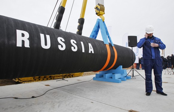 FILE - A Russian construction worker speaks on a mobile phone during a ceremony marking the start of Nord Stream pipeline construction in Portovaya Bay some 170 kms (106 miles) north-west from St. Pet ...