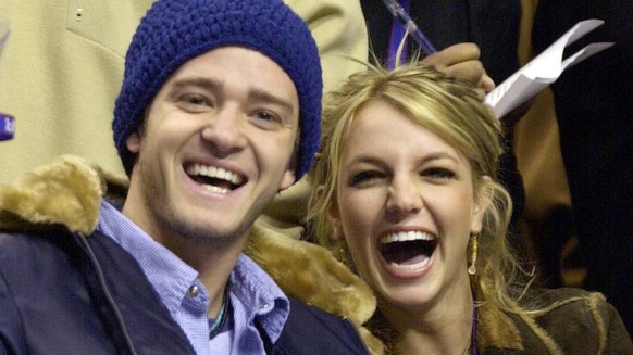 FILE - Justin Timberlake and Britney Spears appear at the 2002 NBA All-Star game in Philadelphia on Feb. 10, 2002. Spears&#039; memoir &quot;The Woman in Me&quot; releases Oct. 24. (AP Photo/Chris Gar ...