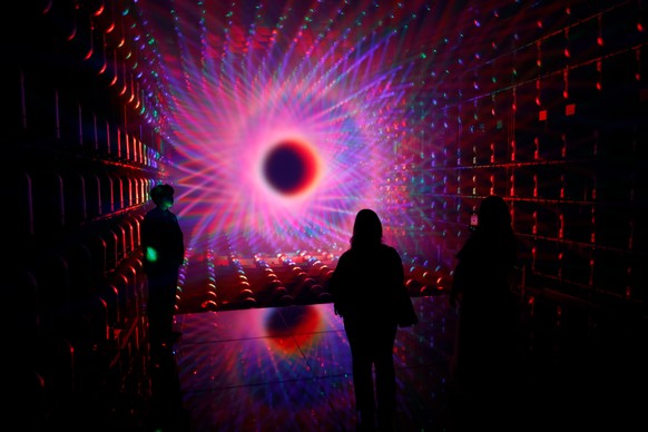 epa13093876 Visitors look at the newly opened installation Light Sculpture - Flow artwork space at teamLab Borderless: Mori Building Digital Art Museum in Azabudai Hills in Tokyo, Japan, 07 July 202 ...