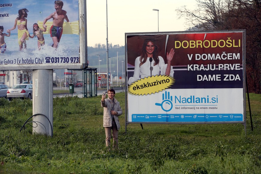 A man takes a selfie in front of placard with a picture of Melania Trump in her hometown Sevnica, Slovenia, December 1, 2016. Banner reads &quot;Welcome in hometown of first lady of U.S.&quot;.REUTERS ...