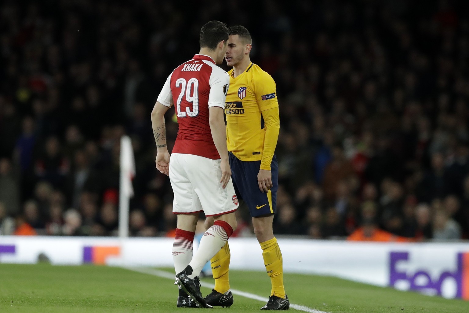 Arsenal&#039;s Granit Xhaka, left, argues with Atletico&#039;s Lucas Hernandez during the Europa League semifinal first leg soccer match between Arsenal FC and Atletico Madrid at Emirates Stadium in L ...