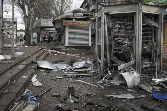 Damaged kiosks seen after a deadly Russian shelling that hit a bus station in Kherson, Ukraine, Tuesday, Feb. 21, 2023. (AP Photo/Nina Lyashonok)