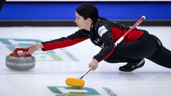 Canada skip Kerri Einarson releases a stone against Switzerland at the women&#039;s world curling championship in Calgary, Alberta, Saturday, May 1, 2021. (Jeff McIntosh/The Canadian Press via AP)