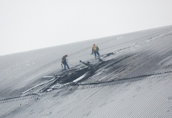 epa11896521 Workers operate on a damaged protective shelter over the remains of the reactor Unit 4 at the Chernobyl nuclear power plant (NPP), near the city of Chernobyl, Ukraine, 14 February 2025, am ...