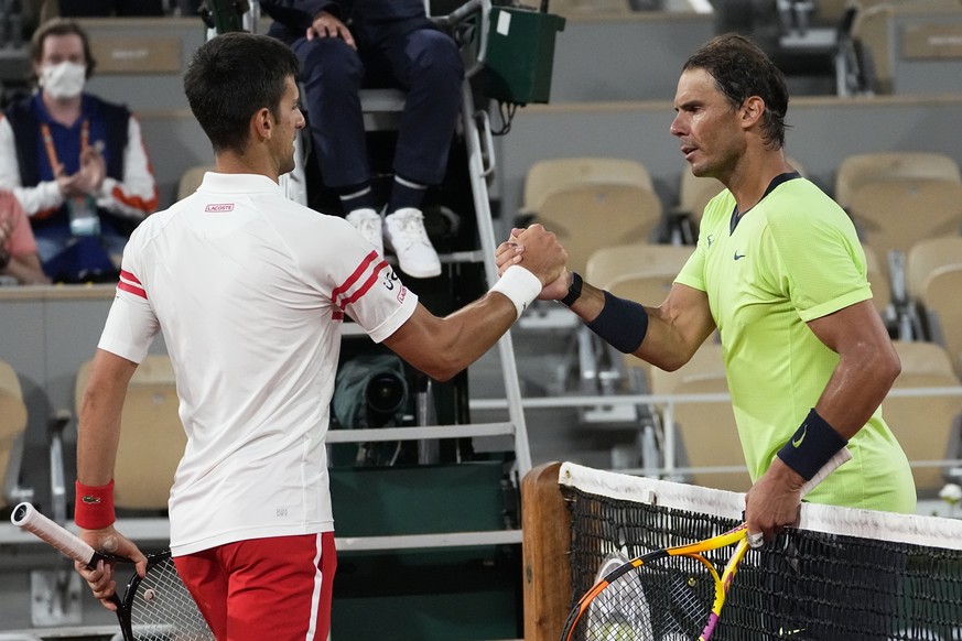 Serbia&#039;s Novak Djokovic, left, shakes hands with Spain&#039;s Rafael Nadal after their semifinal match of the French Open tennis tournament at the Roland Garros stadium Friday, June 11, 2021 in P ...