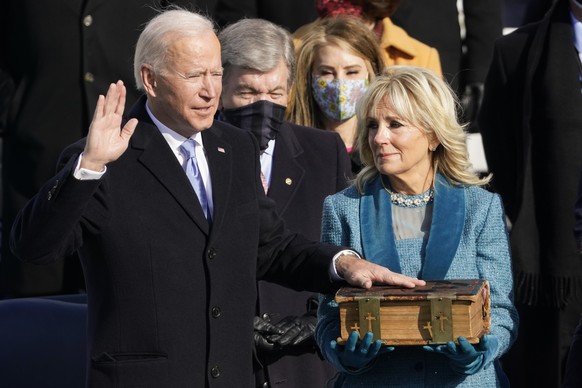 FILE - Joe Biden is sworn in as the 46th president of the United States by Chief Justice John Roberts as Jill Biden holds the Biden family Bible during the 59th Presidential Inauguration at the U.S. C ...