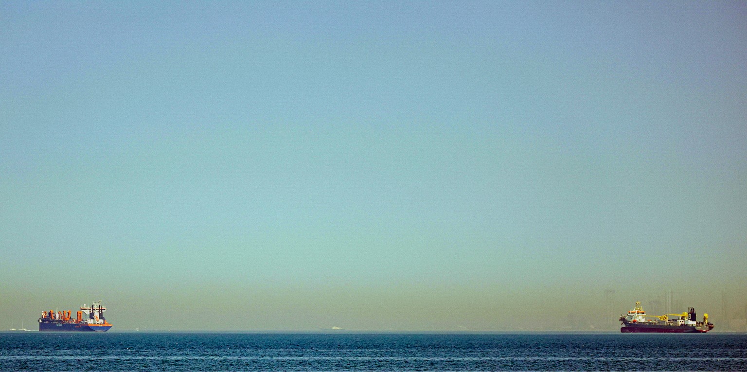 epa12787004 Vessels are seen anchoring off the coast of Dubai, United Arab Emirates, 01 March 2026. Following a joint Israel-US military operation targeting multiple locations across Iran in the early ...