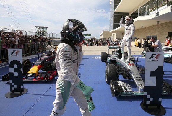 Formula One F1 - U.S. Grand Prix - Circuit of the Americas, Austin, Texas, U.S., 23/10/16. Mercedes&#039; Lewis Hamilton of Britain celebrates his victory atop his car as teammate Nico Rosberg of Germ ...