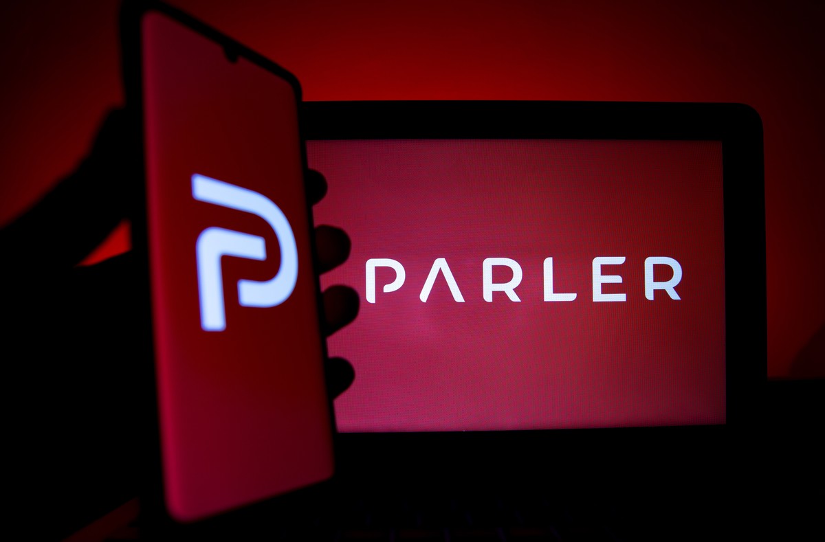 epa08931438 A photo illustration shows the logo of Conservative social media application (app) Parler on a computer and mobile telephone screen, in Paris, France, 11 January 2021. Parler, widely used  ...