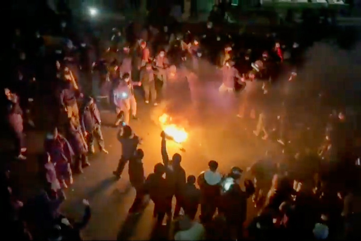 In this frame grab from footage circulating on social media shows protesters dancing and cheering around a bonfire as they take to the streets despite an intensifying crackdown as the Islamic Republic ...