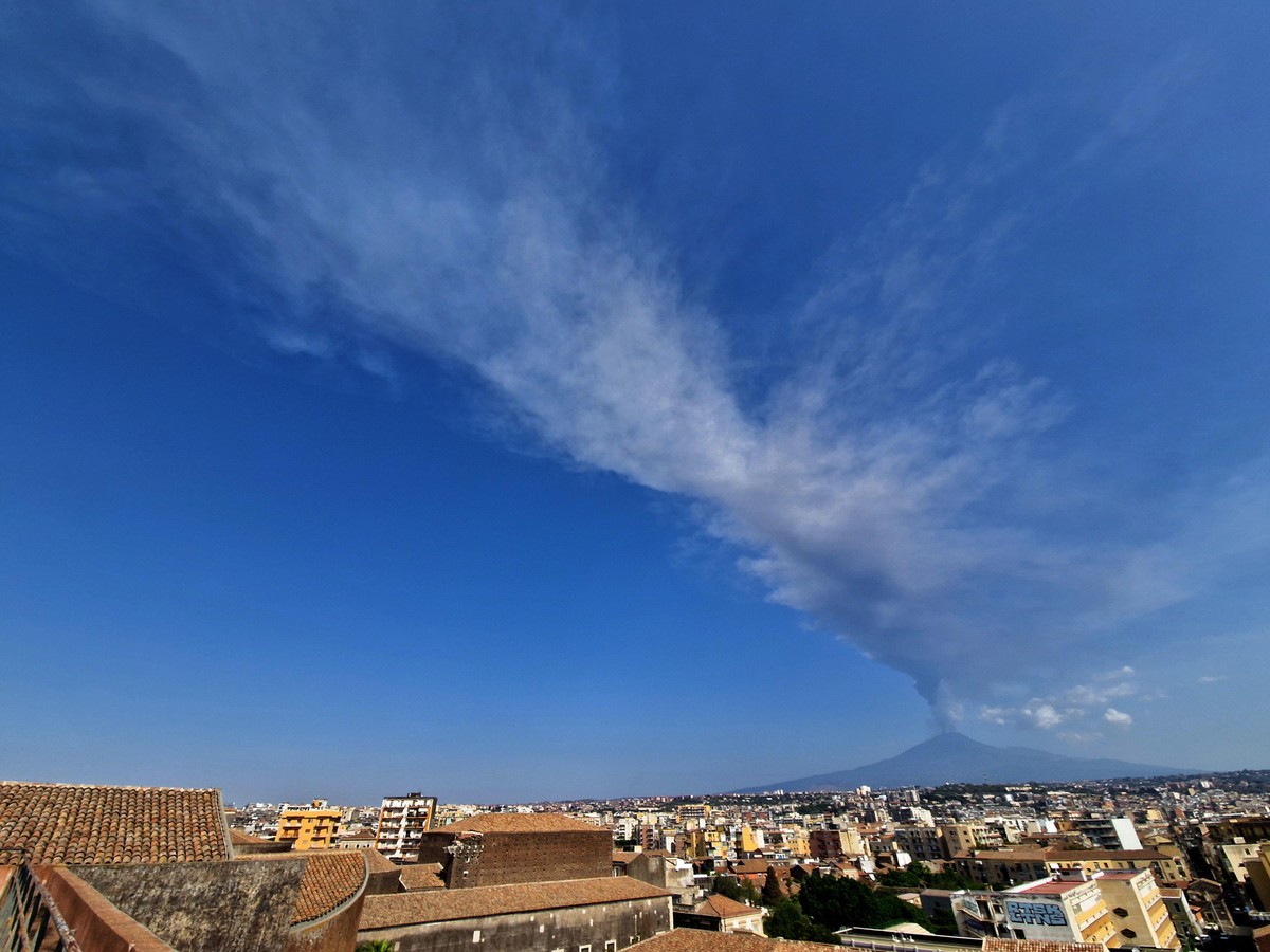 epa11524349 A general view shows a plume of ash and smoke coming out from Mount Etna's volcano Voragine crater, Sicily island, Italy, 04 August 2024. Following the volcanic activities, the crisis ...