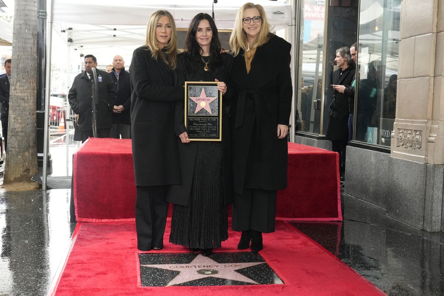 Jennifer Aniston, from left, Courteney Cox, and Lisa Kudrow pose for pictures at the star ceremony where Cox is honored with a star on the Hollywood Walk of Fame on Monday, Feb. 27, 2023, in Los Angel ...