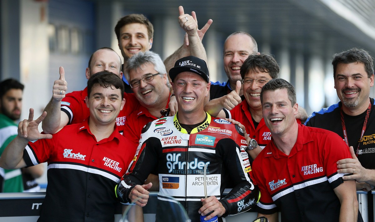 epa05946800 Swiss Moto2 rider Dominique Aegerter (C) celebrates with his team after he finished in third position for Spain's GP race at Jerez de la Frontera's track, southern Spain, 06 May  ...