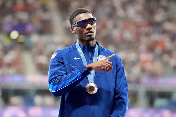 FILE - Bronze medalist Fred Kerley, of the United States, stands on the podium after the men's 100-meter final at the 2024 Summer Olympics, Aug. 5, 2024, in Saint-Denis, France. (AP Photo/Matthia ...