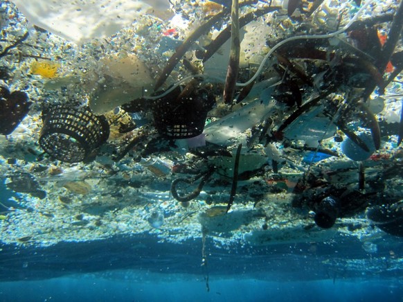 FILE - This file 2008 photo provided by NOAA Pacific Islands Fisheries Science Center shows debris in Hanauma Bay, Hawaii. A new study estimates nearly 270,000 tons of plastic is floating in the world ...