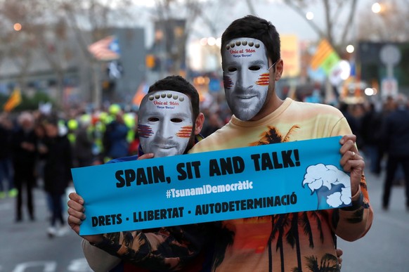 epa08079607 Protesters wear a mask of FC Barcelona Lionel Messi during a protest called by the pro-Catalan independence initiative 'Tsunami Democratic' ahead of a Spanish LaLiga soccer match between FC Barcelona and Real Madrid at the Camp Nou stadium, in Barcelona, Spain, 18 December 2019. Barcelona faces Real Madrid in their Spanish LaLiga soccer match, initially scheduled on 26 October 2019.  EPA/TONI ALBIR