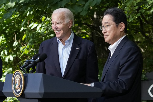 President Joe Biden, left, and Japanese Prime Minister Fumio Kishida react at the end of a joint news conference with South Korean President Yoon Suk Yeol Friday, Aug. 18, 2023, at Camp David, the pre ...