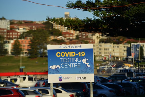 epa09302261 A view of a sign for COVID-19 testing at a pop up clinic at Bondi Beach in Sydney, New South Wales (NSW), Australia, 26 June 2021. All of greater Sydney, the Central Coast, the Blue Mounta ...