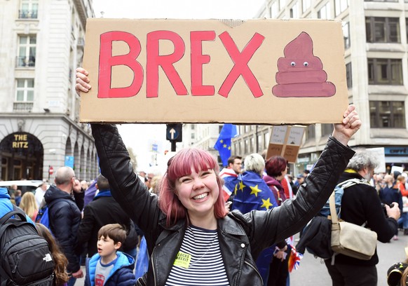 epa07458067 A woman holds a placard as people attend the &#039;Put it to the People&#039; march in London, Britain, 23 March 2019. Hundreds of thousands of people take part in the protest calling for  ...