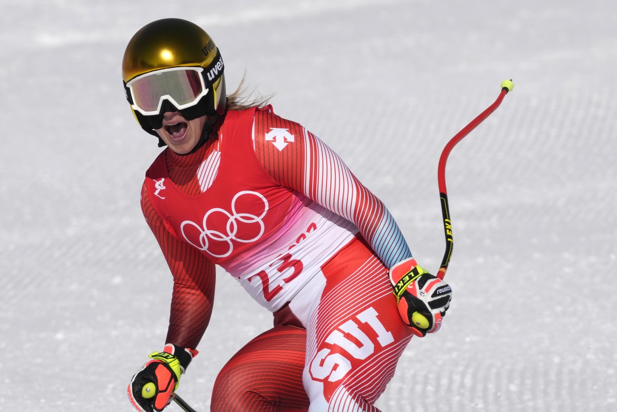 Joana Haehlen, of Switzerland reacts after finishing women's downhill training at the 2022 Winter Olympics, Monday, Feb. 14, 2022, in the Yanqing district of Beijing. (AP Photo/Luca Bruno)