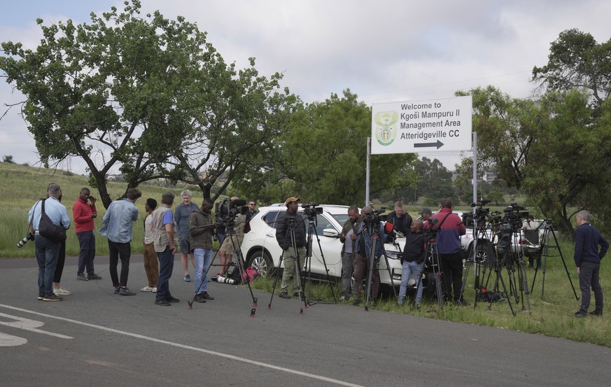 Television crews, photographers and reporters gather outside the gates of the Atteridgeville Correctional Center in the South African capital of Pretoria, South Africa, waiting to catch a glimpse of t ...