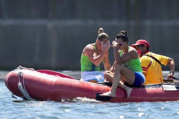 Spela Ponomarenko Janic, left, and Anja Osterman of Slovenia react after flipping their boat while competing in the women's kayak double 500m semifinal at the 2020 Summer Olympics, Tuesday, Aug. ...