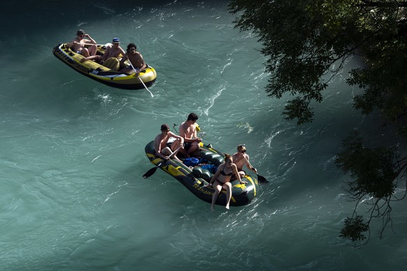 People on two inflatable boats enjoy the sun in the Aare River during the sunny and warm weather, in Bern. Switzerland, Wednesday, June 26, 2019. The forecasts predict hot weather in Switzerland with  ...