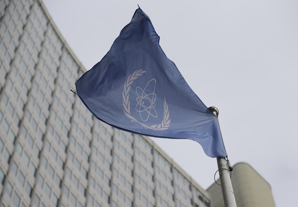FILE - The flag of the International Atomic Energy Agency flies in front of its headquarters during an IAEA Board of Governors meeting in Vienna, Austria, Monday, Feb. 6, 2023. Iran has slowed its enr ...