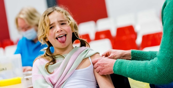 epa09755643 A child is given the HPV vaccine in Dordrecht, The Netherlands, February 14, 2022. Until now, the shots were given to girls aged 13 and older, but the age has been lowered to 10 years and  ...