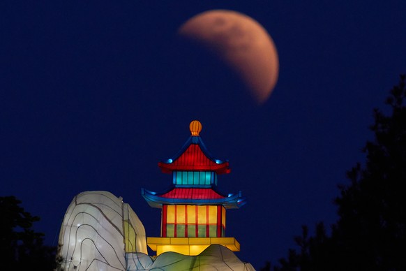 The moon is seen shortly before total eclipse near a lantern in Beijing, Tuesday, March 3, 2026. (AP Photo/Ng Han Guan)
China Blood Moon Eclipse