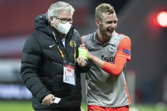 YB's Fabian Lustenberger, right, and Albert Staudenmann, head of communication react after the round of 32, 2nd leg UEFA Europa League match between Germany's Bayer 04 Leverkusen and Switzer ...