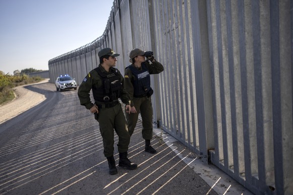 FILE - Police border guards patrol along a border wall near the town of Feres, along the Evros River which forms the frontier between Greece and Turkey, on Oct. 30, 2022. Turkish President Recep Tayyi ...