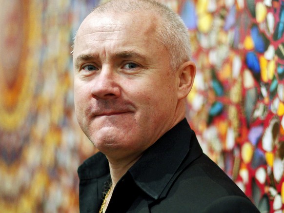 epa04778362 (FILE) The file photo dated April 2, 2012 shows British artist Damien Hirst posing in front of his painting 'I Am Become Death, Shatterer of Worlds' during the retrospective exhibition...