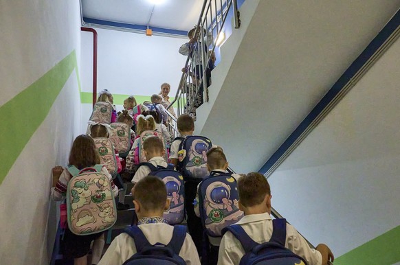 epa12342902 Ukrainian children climb the stairs of a newly built underground school on the first day of the new school year in Kharkiv, Ukraine, 01 September 2025, amid the Russian invasion. In 2025,  ...