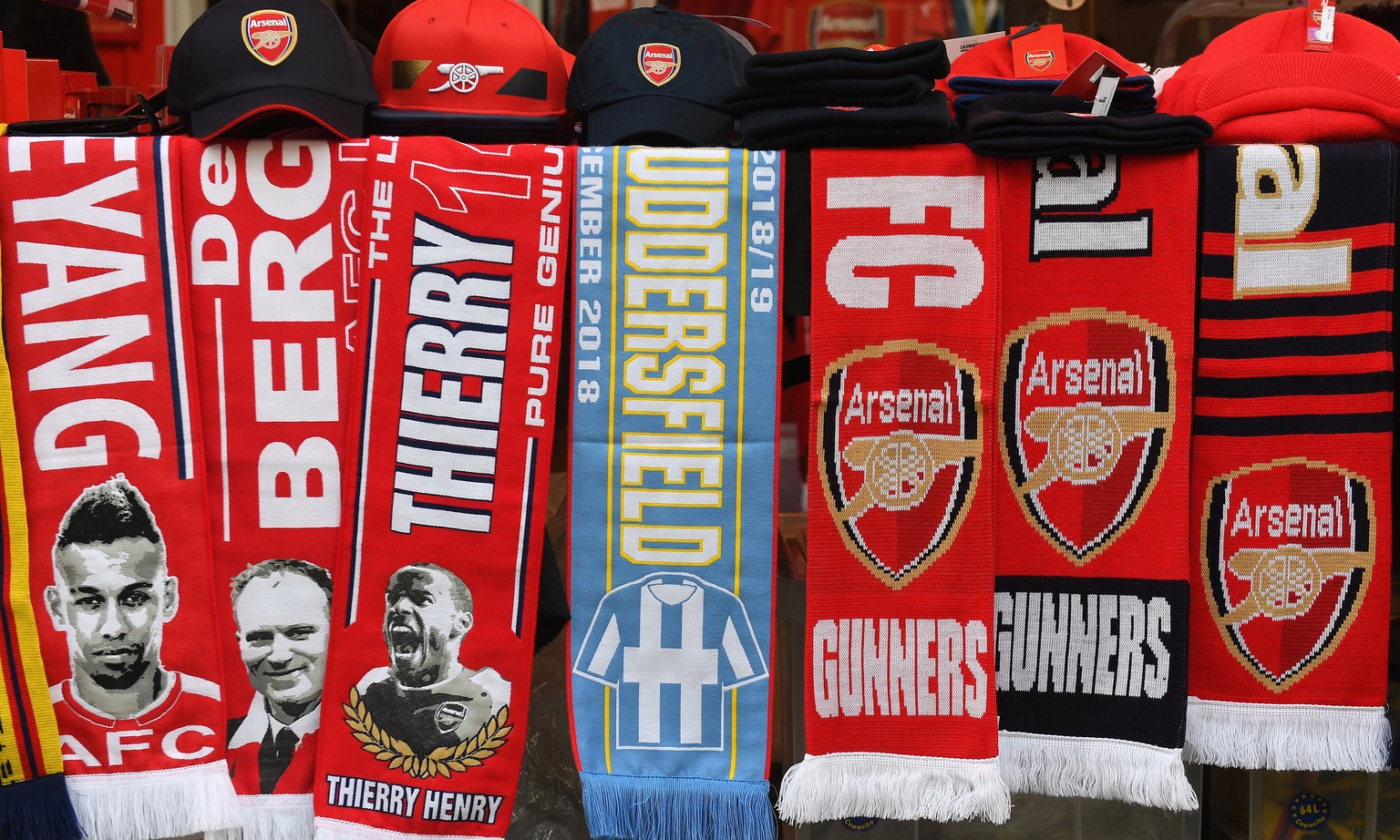 epa07216686 Arsenal and Huddersfield scarves at a fan stall ahead of the English Premier League soccer match between Arsenal FC and Huddersfield Town at the Emirates Stadium in London, Britain, 08 Dec ...