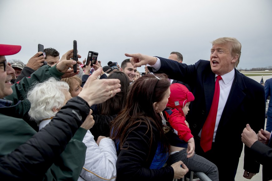 President Donald Trump greets guests on the tarmac as he arrives at Green Bay Austin Straubel International Airport in Green Bay, Wis., Saturday, April 27, 2019, for a rally. (AP Photo/Andrew Harnik)