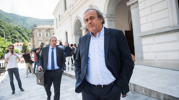 The former president of the the European Football Association (Uefa) Michel Platini, center, is leaving the Swiss Federal Criminal Court in Bellinzona, Switzerland, after the first day of his trial, W ...