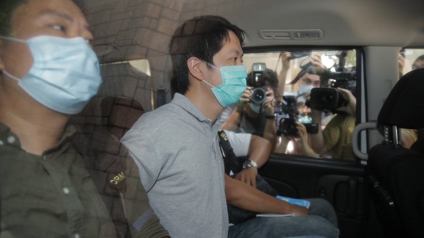 Pro-democracy legislator Ted Hui, center, is arrested by police officers in Hong Kong, Wednesday, Aug. 26, 2020. Hong Kong police arrested 16 people Wednesday on charges related to anti-government pro ...