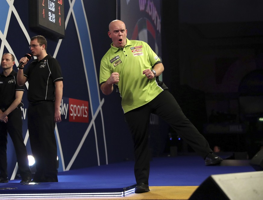 Michael van Gerwen of the Netherlands celebrates beating fellow countryman Raymond van Barneveld in their quarterfinal match on day thirteen of the World Darts Championship at Alexandra Palace, London ...