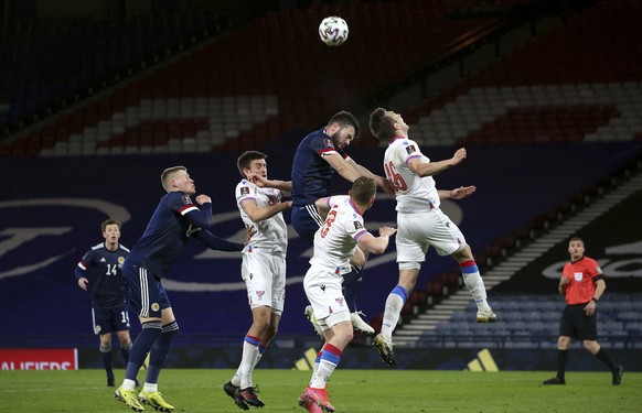 Scotland's Grant Hanley and Faroe Islands' Gunnar Vatnhamar, right, battle for the ball during a World Cup 2022 group F qualifying soccer match between Scotland and Faroe Islands at Hampden ...