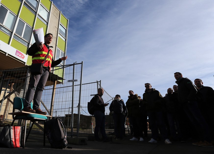 The railway worker Julien Delion speaks during a meeting of the CGT union, in Hendaye, southwestern France, Friday, Dec. 6, 2019. Frustrated travelers are meeting transportation chaos around France fo ...