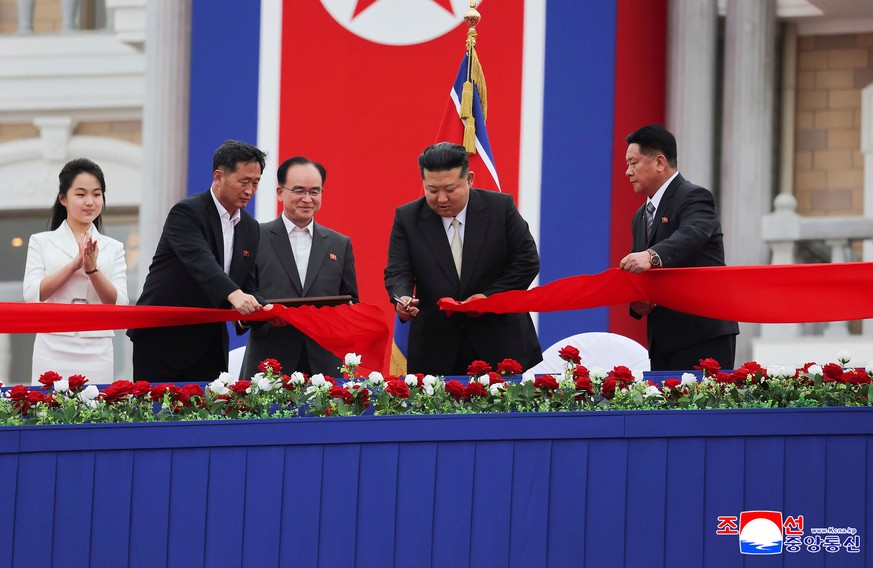 In this photo provided by the North Korean government, North Korean leader Kim Jong Un, second right, with his daughter, left, cuts the inaugural tape during a completion ceremony of the Wonsan-Kalma  ...