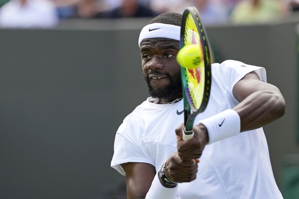 Frances Tiafoe of the US returns to China&#039;s Wu Yibing in a first round men&#039;s singles match on day three of the Wimbledon tennis championships in London, Wednesday, July 5, 2023. (AP Photo/Ki ...